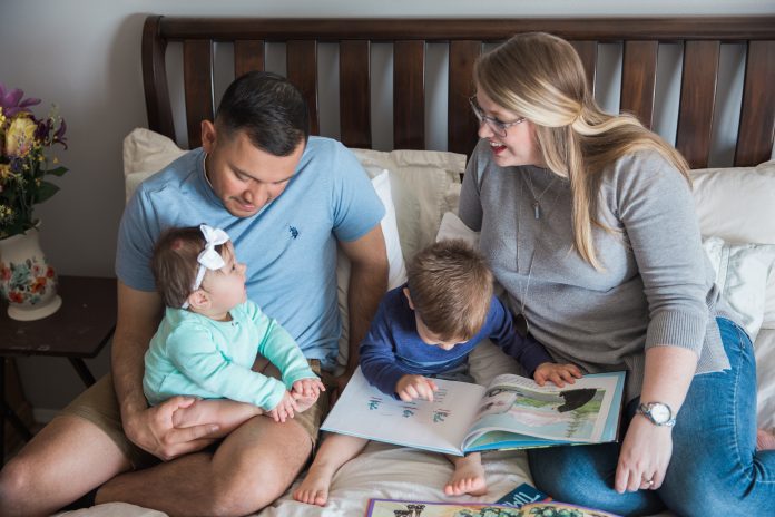 Vidales family sitting on bed together