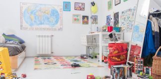 Organizing Kids’ Spaces in Three Easy Places children's room with posters and map on the wall, toys cluttered on the floor and dresser, and a messy bed