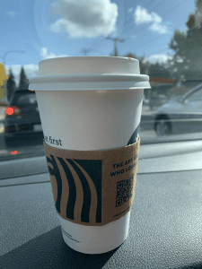 Starbucks coffee on a car dashboard