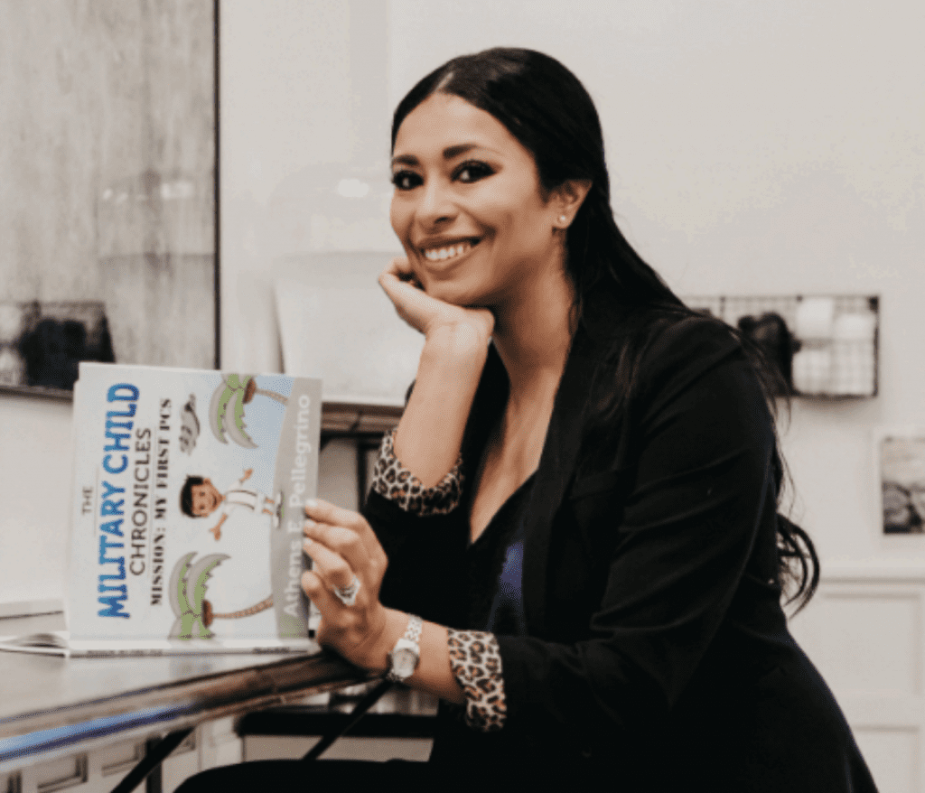 Athens Pellegrino reading her book Military Child Chronicles at a desk