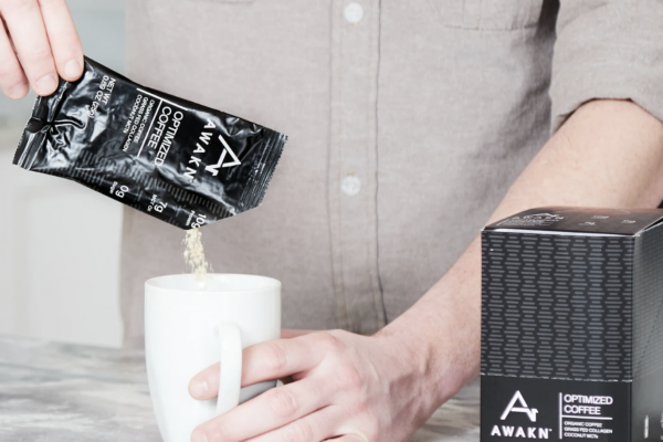 man pouring AWAKN coffee into a mug