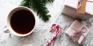 Four Ways to Hate the Holidays a Little Less cup of tea, candy canes, wrapped gifts, and pine branch evoking a holiday feeling