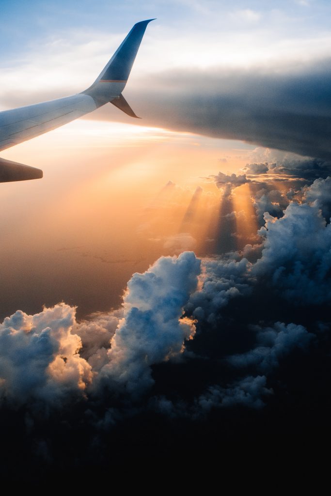 airplane wing in the setting sun skyline