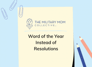 a blue background with a sheet of paper with the MMC logo and "Word of the Year Instead of Resolutions" in text, paper clips and blue and red pens on the sides