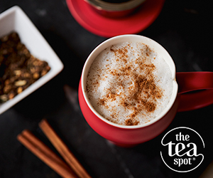 red mug of tea with cinnamon sticks