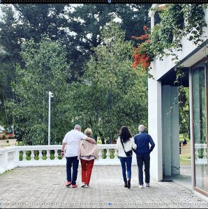 older couple and adult companions walking together outdoors