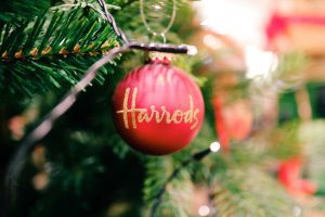 red and gold Harrods Christmas ornament on a tree