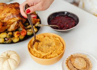 Friday Favorites: Turkey Talk: Conversation Starters for Thanksgiving, Sans Politics thanksgiving meal with turkey, sweet potatoes, and cranberry sauce on a white table