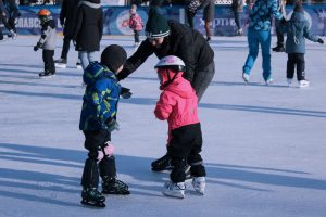 parent and children ice skating