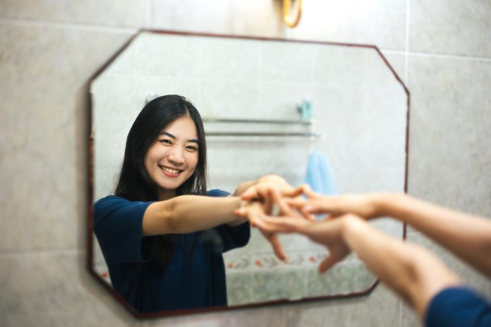 Young,Adult,Smile,Asian,Woman,Practice,Self,Talk,Conversation,With Young adult Asian woman practices positive self-talk in the mirror