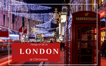 Things To Do In London At Christmas London street at Christmas with lights strung up and festive decorations