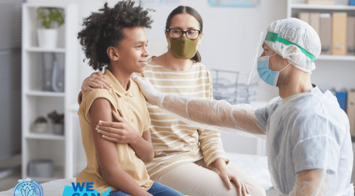 son with mother at a doctor's office holding a piece of gauze to his arm while a physician in PPE rests a hand on his shoulder, signaling comfort. We Can Do This and MMC logos in the bottom left corner