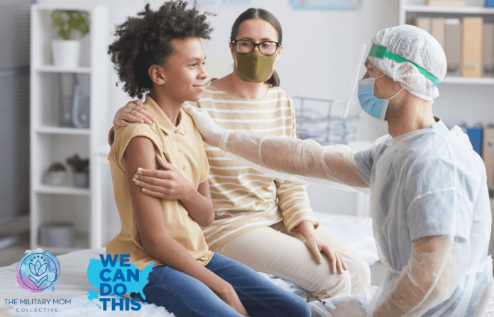 son with mother at a doctor's office holding a piece of gauze to his arm while a physician in PPE rests a hand on his shoulder, signaling comfort. We Can Do This and MMC logos in the bottom left corner