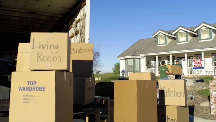 moving boxes outside a house on a sunny day