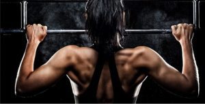 close up of a woman doing a pull-up exercise