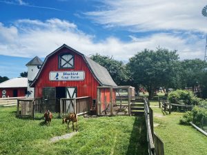 red barn with animals out front