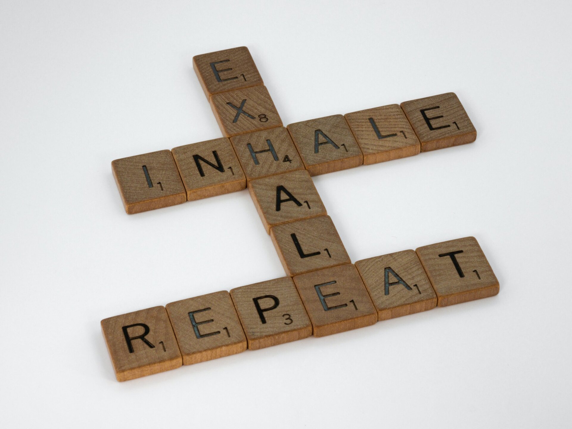 Scrabble tiles that say "exhale, inhale, repeat"