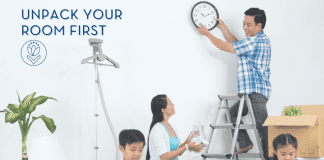 Unpack Your Room First family unpacking a house with Dad hanging a clock. "Unpack Your Room First" in text and MMC logo