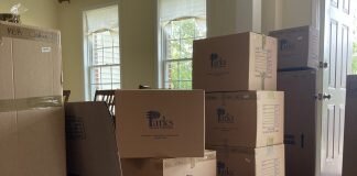 When Not Moving Isn’t The Same As Staying Still Cardboard moving boxes are stacked up at the door.