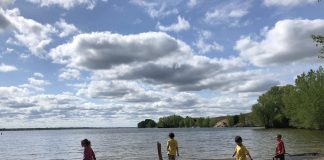 3 Things I Resigned from This Summer 4 kids run across a beach at a lake
