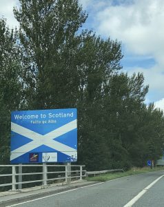 Road sign shows the Scotland flag and reads, 'Welcome to Scotland'.