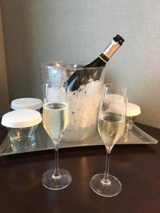 Celebrating New Year's Eve with a bottle of champagne in an ice bucket and two glasses.