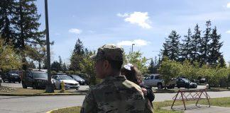 Soldier walking with children in arms