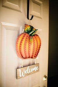 Front door with pumpkin door hanger