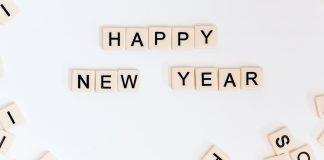 Happy New Year is spelled out in Scrabble tiles.