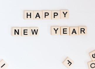 Happy New Year is spelled out in Scrabble tiles.