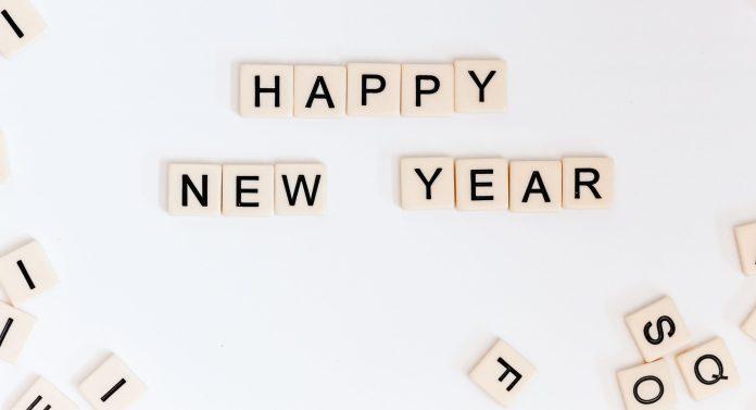 Happy New Year is spelled out in Scrabble tiles.