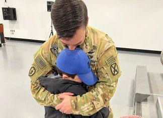 Child saying goodbye to father before deployment