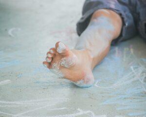 child doing sensory play with chalk