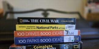 How to Build Your Base Bucket List stack of 5 travel guide books