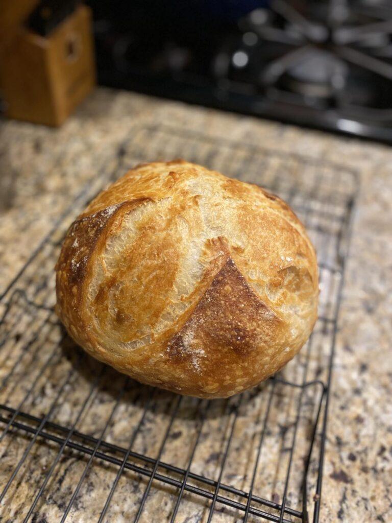 Sourdough loaf of bread on cooling rack