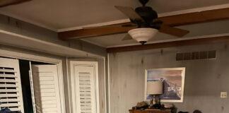 Picture of a messy living room, laundry everywhere, that obviously belongs to a burnt-out mom