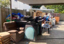 Hurricane Preparedness: Lessons from After the Storm furniture pile along gate of flooded items ready for trash pickup