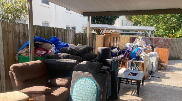 Hurricane Preparedness: Lessons from After the Storm furniture pile along gate of flooded items ready for trash pickup