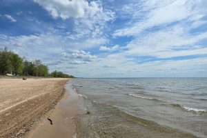 Lake Ontario beach with blue sky, only 40 minutes from Fort Drum