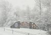 Welcome to Fort Drum sign with snow falling