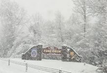 Welcome to Fort Drum sign with snow falling