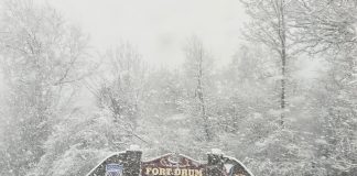 Welcome to Fort Drum sign with snow falling