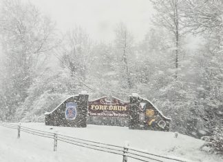 Welcome to Fort Drum sign with snow falling