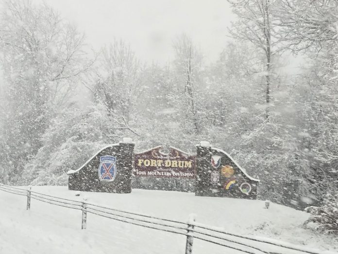 20241129_142525 Welcome to Fort Drum sign with snow falling